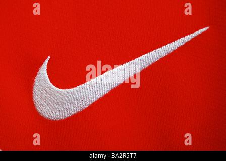 Gros plan photo de Nike Swoosh sur le maillot de football rouge. Banque D'Images