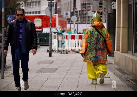 Francfort-sur-le-main, Allemagne. 14 mars 2025. Un homme passe devant un autre homme vêtu d'un costume. Banque D'Images