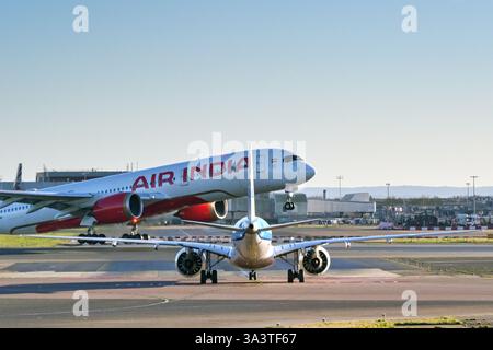 Londres, Angleterre, Royaume-Uni - 3 janvier 2025 : petit jet attendant de traverser une piste à l'aéroport de Londres Heathrow pendant le décollage d'un Airbus A350 d'Air India Banque D'Images