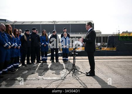 Le premier ministre Sir Keir Starmer parle aux sous-mariniers de la Royal Navy du sous-marin nucléaire HMS Agamemnon et aux apprentis du système BAE à l'extérieur de l'usine BAE System, Barrow-in-Furness, Cumbria, au nord-ouest de l'Angleterre. Date de la photo : jeudi 20 mars 2025. Banque D'Images