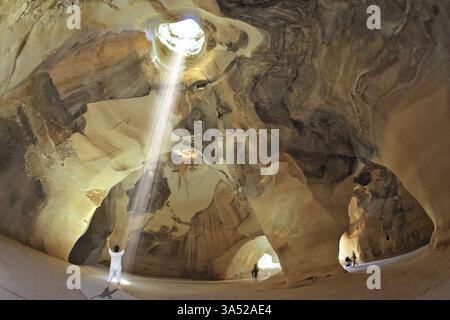 Cours de yoga dans la grotte Beit Guvrin, Israël. Femme en blanc effectue asana Sun salutation Banque D'Images
