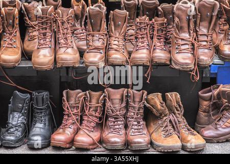 Bottes brunes de combat d'occasion exposées au marché du dimanche de Brick Lane à Londres, en Angleterre Banque D'Images