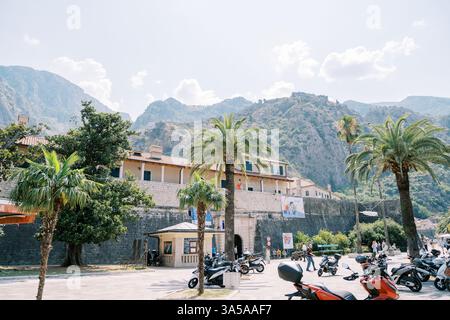 Monténégro, Kotor - 07 juillet 2024 : place avec scooters garés en face de l'ancienne porte maritime. Kotor, Monténégro Banque D'Images