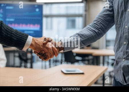Vue rapprochée de la poignée de main entre deux partenaires commerciaux au bureau. Banque D'Images