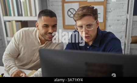 Hommes travaillant dans un environnement de bureau, discutant des affaires devant un ordinateur avec des étagères en arrière-plan, soulignant le travail d'équipe et la collaboration i. Banque D'Images