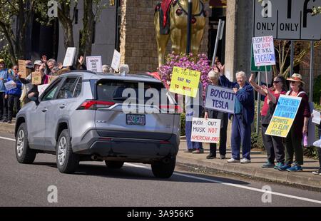 Des manifestants pro-démocratie appellent au boycott de Tesla à Eugene, Oregon, le 29 mars 2025. Banque D'Images