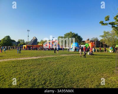 Toronto, ON, Canada – 31 mai 2024 : les familles se rassemblent autour de grands toboggans gonflables et de parcours d’obstacles lors d’un événement pour enfants par un après-midi ensoleillé. Banque D'Images