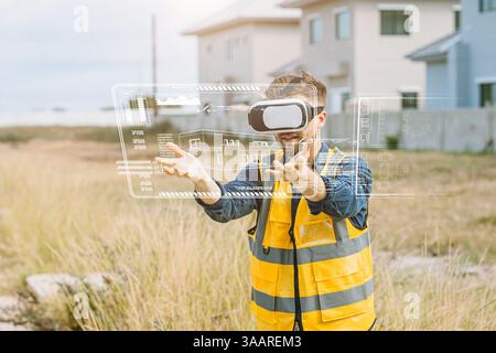 Ingénieur travailleur masculin utilisant la technologie de réalité visuelle VR ou réalité augmentée AR dans l'industrie de la construction. Innovation numérique moderne dans le domaine de l'ingénierie Banque D'Images
