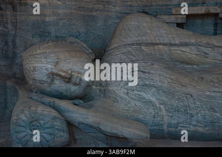 Vue rapprochée d'une ancienne sculpture en pierre représentant le visage serein d'un Bouddha couché. Située au Sri Lanka, cette œuvre reflète spirituel et h. Banque D'Images