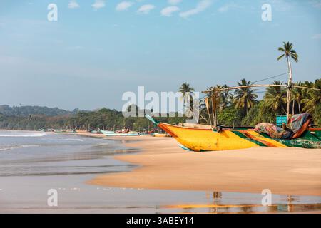 Bateaux de pêche sur une plage de sable idyllique près de Tangalla au Sri Lanka Banque D'Images