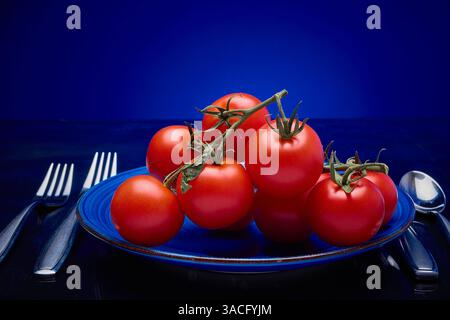 Tomates, vigne mûrie sur assiette Banque D'Images