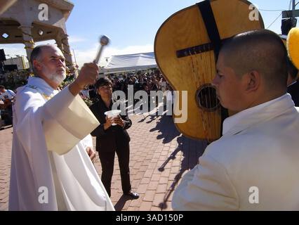 22 novembre 2005 - East Los Angeles, Californie, États-Unis - Un prêtre traverse Mariachi Plaza et saupouille de l'eau bénite sur les musiciens et leurs instruments à Boyle Heights, un quartier à l'est du centre-ville de Los Angeles, le mardi 22 novembre 2005 lors du festival annuel Mariachi, qui honore Sainte Cécile, la patronne des musiciens. (Crédit image : © Brian Cahn/ZUMAPRESS.com) Banque D'Images