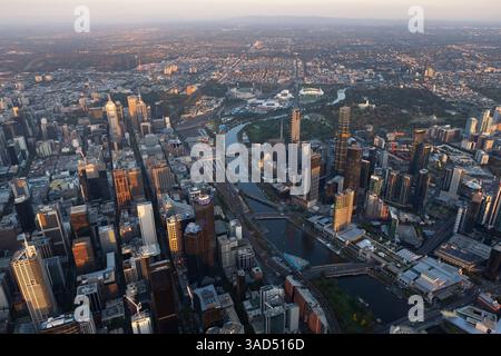 Vue aérienne de la Yarra River et du quartier des affaires de Melbourne vers l'est, tandis que la lumière du coucher du soleil attrape les gratte-ciel. Banque D'Images
