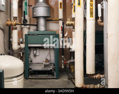 Système de chauffage à eau chaude dans la chaufferie du bâtiment résidentiel. Chauffe-eau au gaz naturel, réservoir d'eau chaude et tuyaux d'eau chaude et froide. Gaz sans danger, technique au gaz Banque D'Images
