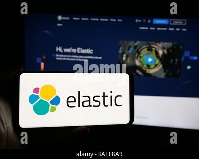 Stuttgart, Allemagne - 11-07-2024 : personne tenant un smartphone avec le logo de la société de logiciels d'IA Elastic N.V. sur l'écran en face du site Web. Concentrez-vous sur l'affichage du téléphone. Banque D'Images