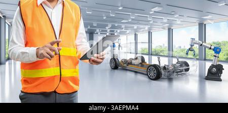 Ingénieur asiatique ou technicien travaillent avec l'usine d'automobile d'automatisation de voiture ev avec fond de verdure Banque D'Images