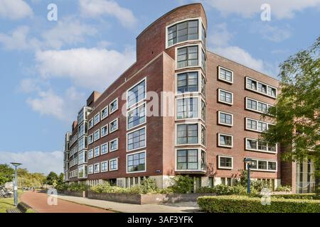 Cet immeuble moderne saisissant dispose d'un design architectural unique, de grandes fenêtres et d'un beau paysage environnant, améliorant l'esthétique de la vie urbaine. Banque D'Images