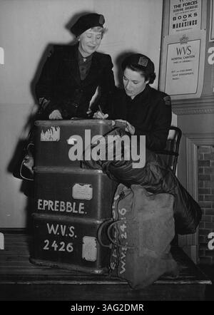 First British Women for Korea -- le préambule de MRS (à gauche) photographié au siège de WVS à Londres aujourd'hui, avec Mlle Whittall, qui est vue s'adressant aux étiquettes sur les 176 livres de bagages de MRS Probbie, avant qu'ils ne partent par avion pour la Corée. Partant pour la Corée aujourd'hui est une équipe de deux membres de WVS, MRS Emily Prebble, 43 ans, et Patricia Whittall, 32 ans, toutes deux de Londres, elles feront du travail social dans la cantine et le camp de transit de NAAFI à Pusan, et seront les seules femmes britanniques en Corée. 02 novembre 1951. (Photo Fox photos). Banque D'Images