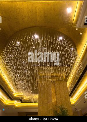 22 mars 2025. Abu Dhabi. EAU. Hôtel Emirates Palace. Détail architectural de luxueux plafond doré et lustre. Banque D'Images