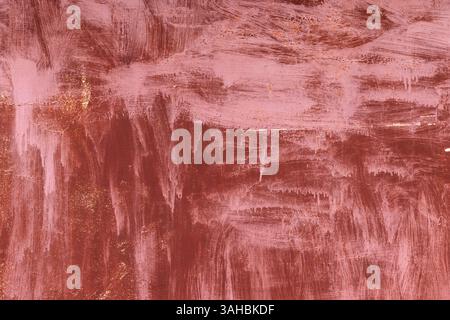 Surface métallique texturée avec des traits de tons roses et cuivrés avec des reflets métalliques, évoquant une esthétique artistique, rustique et moderne adaptée Banque D'Images