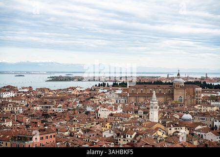 Une impressionnante photographie aérienne de Venise, en Italie, mettant l'accent sur la mer des toits de tuiles rouges qui définissent son centre historique. L'image s'étend pour inclure Banque D'Images