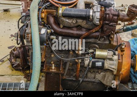 Taean, Corée du Sud. 14 août 2019 : gros plan d'un moteur intérieur rouillé exposé à des éléments assis sur une jetée en béton humide Banque D'Images