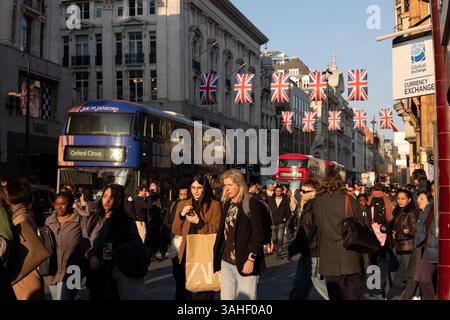 Les acheteurs sur une rue animée d'Oxford Street pendant l'heure de pointe de la fin de la journée alors que les touristes et les travailleurs s'animent dans la rue, Londres, Angleterre, Royaume-Uni Banque D'Images