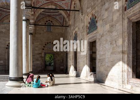 Istanbul, Turquie, 2 mai 2024, cour intérieure de ce qui semble être la mosquée Suleymaniye dans le quartier de Fatih avec des femmes assises sur le marbre Banque D'Images