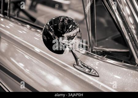 Gros plan du rétroviseur extérieur brillant sur une voiture classique de couleur sépia. Banque D'Images