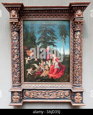Une peinture de Lucas Cranach l'ancien, créée en 1504, représentant la fuite en Égypte. La peinture montre la Sainte famille voyageant à travers un paysage tranquille, reflétant le moment serein dans ce récit biblique. Banque D'Images