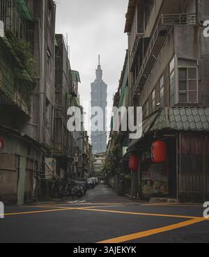 Personne tenant un parapluie violet et Taipei 101 bâtiment dans le fond d'une rue de la ville à Taiwan. Photo prise sur un nuageux sur un jour nuageux Banque D'Images