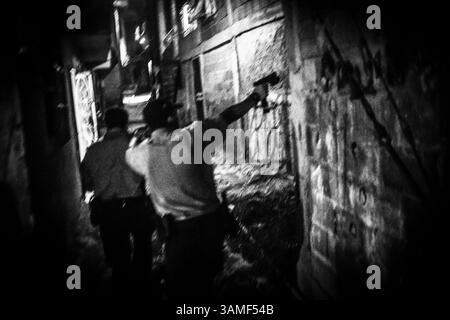 19 juillet 2013 - Caracas, Miranda, Venezuela - les policiers qui patrouillent dans les bidonvilles ne portent pas d'équipement tactique ni de mitrailleuses, mais effectuent toujours des patrouilles à pied dans les ruelles serpentine à la recherche d'armes et de drogues. Ils marchent nerveusement à travers les rues sombres avec leurs pistolets tirés, mais la nuit retournent à leurs maisons dans les Barrios voisins. (Crédit image : © Charles Mostoller/zReportage.com via ZUMA Press) Banque D'Images