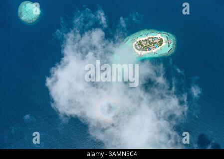 Vue aérienne de l'île d'Ithaafushi avec des nuages bas, archipels des Maldives. Banque D'Images
