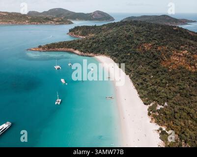 Vue aérienne de South Whitehaven Beach, élue la meilleure plage du monde, avec des bateaux ancrés le long de la rive et des gens bronzer sur la plage, Quee Banque D'Images