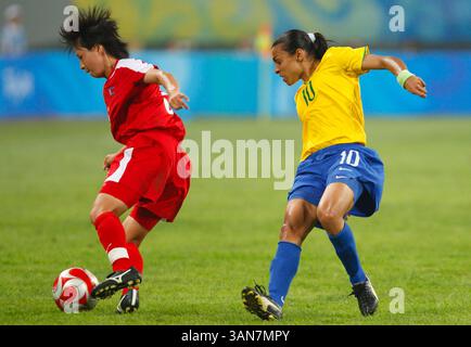 Marta du Brésil (R) défend contre Song Jong Sun de la Corée du Nord (R) lors d’un match du Groupe F aux Jeux Olympiques de Pékin le 9 août 2008 à Shenyang, en Chine. Usage éditorial exclusif. Utilisation commerciale interdite. (Photographie de Jonathan Paul Larsen / Diadem images) Banque D'Images