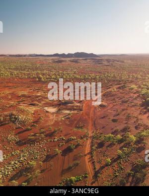 Vue aérienne d'un vaste paysage aride avec terre rouge et dunes de sable, aire de repos de House Creek, Nanutarra, Australie. Banque D'Images