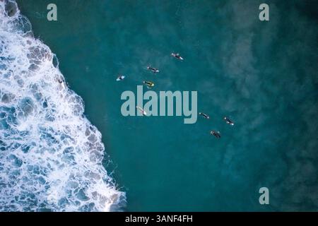 Vue aérienne des surfeurs dans les vagues de l'océan, The Pass Beach, Byron Bay, Australie. Banque D'Images