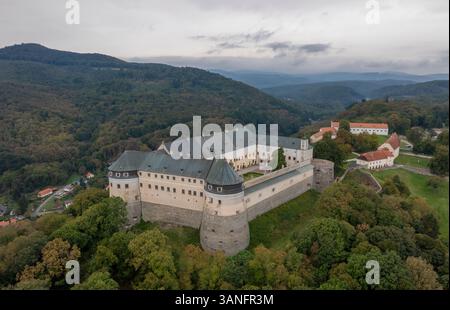 Vue aérienne du château de Cerveny Kamen entouré de verdure luxuriante et de montagnes majestueuses, Casta, Slovaquie. Banque D'Images