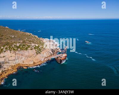 Vue aérienne de la barge de grue naufragée est au large de la côte de Sandy Bay, Cape Town, Western Cape Province, Afrique du Sud. Banque D'Images