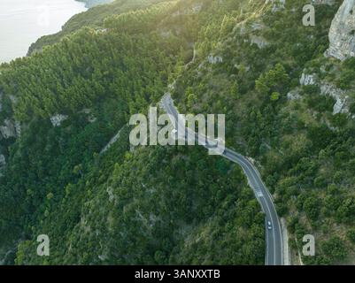 Vue aérienne de la route amalfitaine route serpentine traversant la forêt le long de la côte amalfitaine près de Positano, Salerne, Campanie, Italie. Banque D'Images