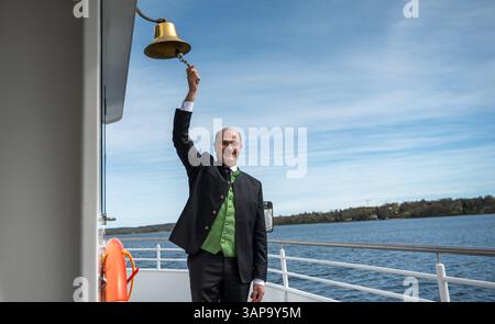 Starnberg, Allemagne. 16 avril 2025. Albert Füracker, ministre bavarois des Finances (CSU), sonne une cloche sur un bateau d'excursion sur le lac de Starnberg lors d'un événement de presse marquant le début de la saison des croisières sur le lac bavarois. Crédit : Leonie Asendorpf/dpa/Alamy Live News Banque D'Images
