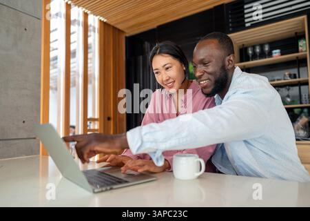 Un couple heureux et multinational qui sont des nomades numériques et travaillent dans un pays différent chaque mois Banque D'Images