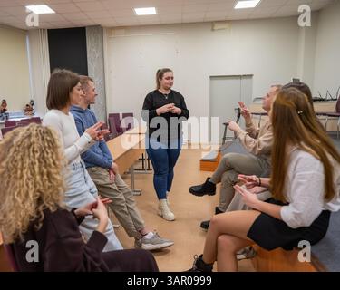 Les jeunes communiquent en langue des signes dans une salle de classe universitaire. Banque D'Images
