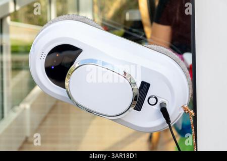 Le robot de nettoyage de vitres motorisé fonctionne à l'extérieur de la fenêtre Banque D'Images