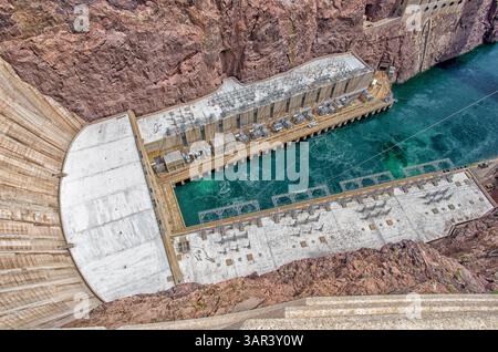 Vue aérienne du barrage Hoover et de la station hydroélectrique avec de l'eau turquoise et des murs en béton situés dans un canyon du désert sur le fleuve Colorado. Banque D'Images