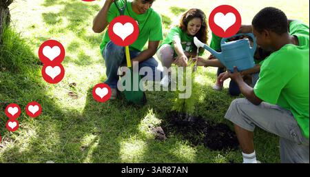 Image de cœurs rouges sur un groupe diversifié heureux ramassant des ordures dans la campagne Banque D'Images