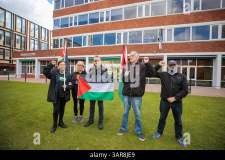 Les gens prennent part à une manifestation pro-palestinienne devant le bâtiment administratif de l'Université Queens de Belfast (QUB), en Irlande du Nord, pour montrer leur soutien aux neuf membres de l'Assemblée QUB Palestine qui ont occupé le bâtiment du campus pour montrer leur soutien à Mahmoud Khalil. Khalil a été enlevé de son immeuble d'habitation à New York par des agents de l'Immigration and Customs Enforcement (ICE) des États-Unis le 8 mars 2025, pour son implication en tant que négociateur principal dans le campement dans les occupations pro-palestiniennes du campus de l'Université Columbia en 2024. Date de la photo : jeudi 17 avril 2025. Banque D'Images
