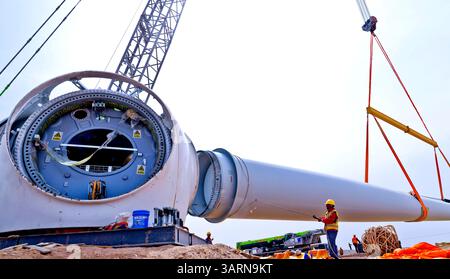 ZHANGYE, CHINE - 17 AVRIL 2025 - sur le site de construction du projet éolien de 100 000 kilowatts de Xinruisheng New Energy à Yanchi Beach, les constructeurs assemblent des pales d'éoliennes dans la ville de Zhangye, province du Gansu, Chine, le 17 avril 2025. Banque D'Images