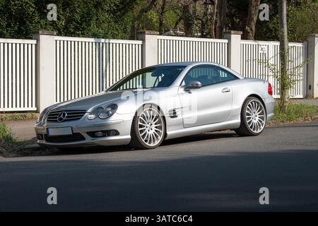 Mercedes-Benz R 230 SL 55 AMG en couleur argent. Voiture de luxe d'un constructeur allemand parking dans une rue. Véhicule cabriolet avec toit rigide fermé Banque D'Images