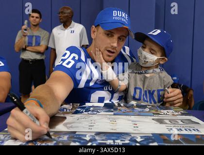 20 août 2016 - Durham, Caroline du Nord, États-Unis - Corbin McCarthy de Duke signe des autographes pour les fans alors que Beckham Prescott, 4 ans, tente d'attirer son attention au Wallace Wade Stadium le 20 août 2016 à Durham, Caroline du Nord Prescott espérait qu'une fête pour son 4e anniversaire aurait une sorte de thème de football et deux joueurs de football de Duke qu'il a rencontrés à la fête, McCarthy et son coéquipier Ben Humphreys, sont devenus de Beckham, nouveaux ''grands frères'''''' L'OMS est traitée à Duke pour la PMD (maladie de Pelizaeus-Merzbacher), une leucodystrophie rare qui affecte le système nerveux central. Beckham, à son tour, est une source d'inspiration pour les joueurs. (CRED Banque D'Images